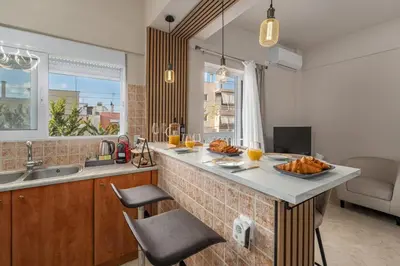 a kitchen with a counter with a plate of food on it at Cozy Athens Stay near Metro Mall Casa Antigone in Athens