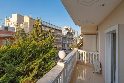 a balcony of a building with a tree on it at Cozy Athens Stay near Metro Mall Casa Antigone in Athens