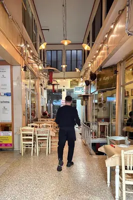 a man standing in front of a restaurant at Panoramic View Athenian Loft in Athens
