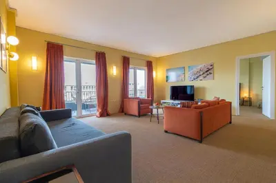 a living room with a couch and chairs and a television at Panoramic View Athenian Loft in Athens