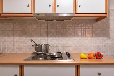 a kitchen counter with a stove with pots and pans at Lemon Garden Kolonaki Apartment in Athens