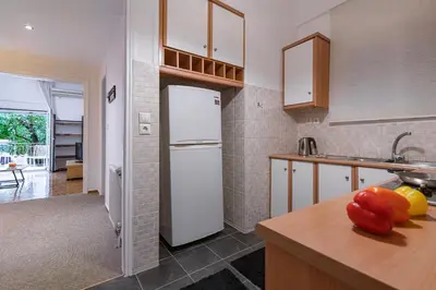 a kitchen with a white refrigerator and a counter at Lemon Garden Kolonaki Apartment in Athens