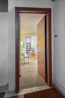 a door leading into a room with a table at Lemon Garden Kolonaki Apartment in Athens