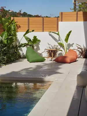 a patio with a pool and some plants at Camara Athens Riviera Home in Aghia Marina