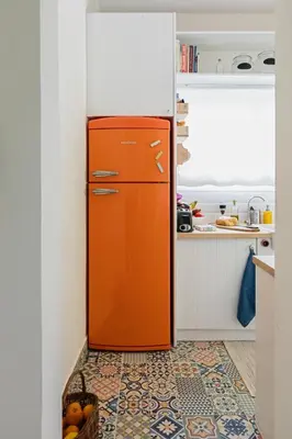 an orange refrigerator in a kitchen with a basket of fruit at Camara Athens Riviera Home in Aghia Marina