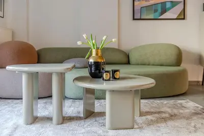 a living room with two tables and a couch at Elysian Condo, Koukaki in Athens