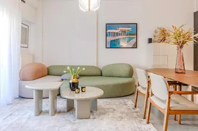 a living room with a couch and a table at Elysian Condo, Koukaki in Athens