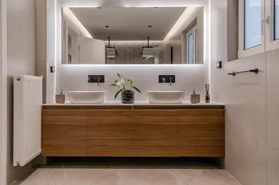 a bathroom with two sinks and a mirror at Elysian Condo, Koukaki in Athens