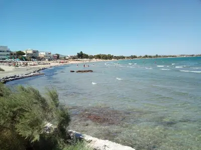 a beach with a bunch of people in the water at Cozy House Oasis 15 min to airport & port, 35 min from Acropolis in Papangeláki
