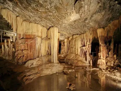 a cave with some water and rock formations at Cozy House Oasis 15 min to airport & port, 35 min from Acropolis in Papangeláki