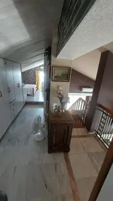 a room with a bedroom with a bed and a table at Vacation Villa 5 bedrooms in Paianía