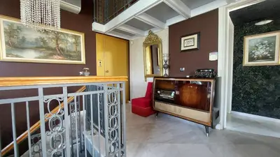 a living room with a television and a staircase at Vacation Villa 5 bedrooms in Paianía