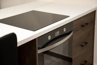 a kitchen counter with a sink and a stove at Kalma Luxury Living Athens in Athens