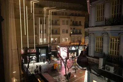 a view of a city street at night with buildings at Kalma Luxury Living Athens in Athens