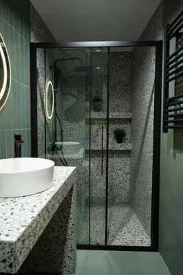 a bathroom with a glass shower and a sink at Kalma Luxury Living Athens in Athens