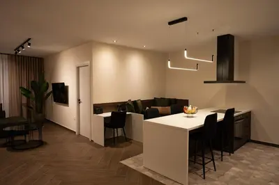 a kitchen and living room with a table and chairs at Kalma Luxury Living Athens in Athens