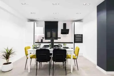 a kitchen with a dining room table and yellow chairs at Luxury 3br Home at Hip Pangrati in Athens