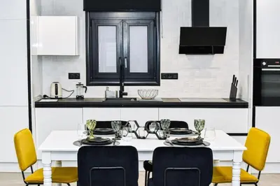 a kitchen with a white table and yellow chairs at Luxury 3br Home at Hip Pangrati in Athens