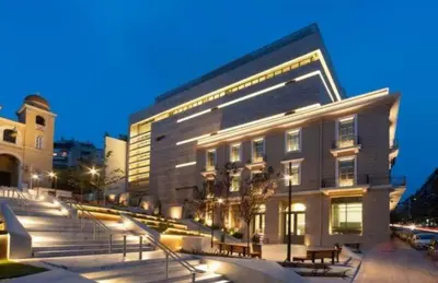a building with benches in front of it at night at Luxury 3br Home at Hip Pangrati in Athens