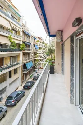 a balcony of a building with cars parked on the street at Luxury 3br Home at Hip Pangrati in Athens
