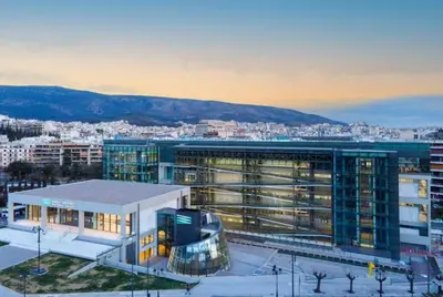 a large building in front of a city at Luxury 3br Home at Hip Pangrati in Athens