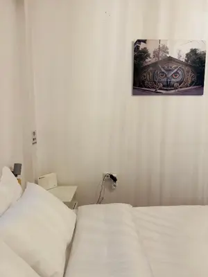 a bedroom with a bed and a picture on the wall at Eclectic Studio Exarcheia for 2 in Athens