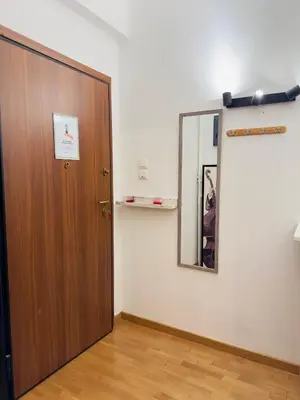 a wooden door in a room with a mirror at Eclectic Studio Exarcheia for 2 in Athens