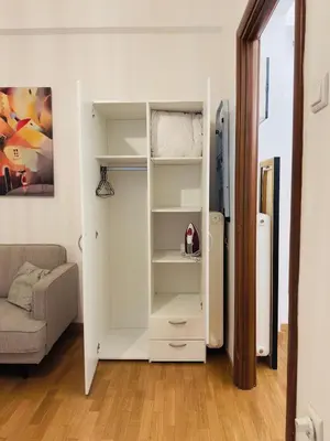 a living room with a white book shelf at Eclectic Studio Exarcheia for 2 in Athens