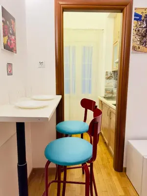 a kitchen with two chairs and a table and a mirror at Eclectic Studio Exarcheia for 2 in Athens