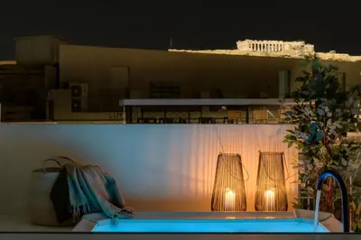 a bathroom sink with two lights on a wall at Bright Acropolis Loft Plunge Pool in Athens