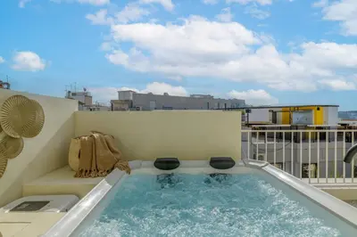 a hot tub on the balcony of a building at Bright Acropolis Loft Plunge Pool in Athens