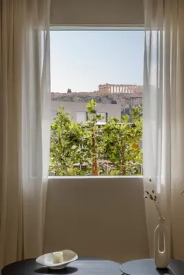 a window with a table and a cup of coffee at Bright Acropolis Loft Plunge Pool in Athens