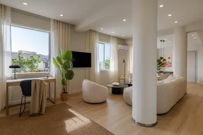 a living room with a couch and a table at Bright Acropolis Loft Plunge Pool in Athens