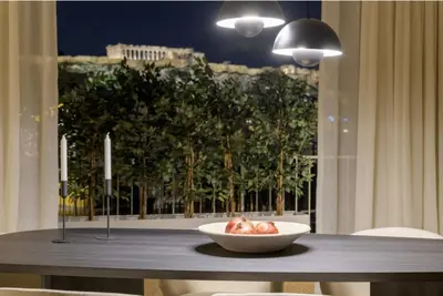 a bowl of food on a table with a window at Bright Acropolis Loft Plunge Pool in Athens