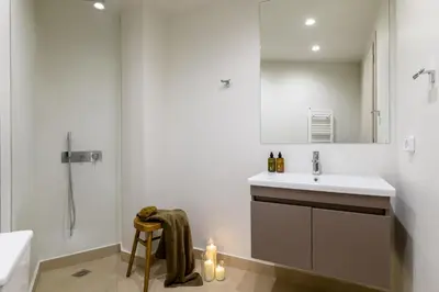 a bathroom with a sink and a toilet and a shower at Bright Acropolis Loft Plunge Pool in Athens
