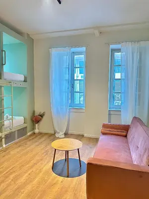 a living room with a couch and a table at Pink Pineapple in Athens