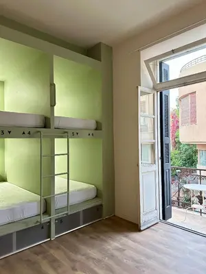 a room with two bunk beds and a sliding glass door at Pink Pineapple in Athens