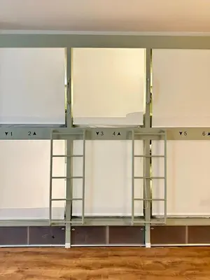 a row of white cabinets in a room at Pink Pineapple in Athens