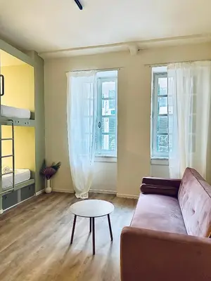 a living room with a couch and a table at Pink Pineapple in Athens