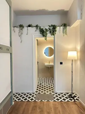 a hallway with a door leading to a bathroom at Pink Pineapple in Athens