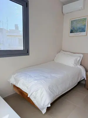 a white bed in a room with a window at M&H and their friends A in Athens