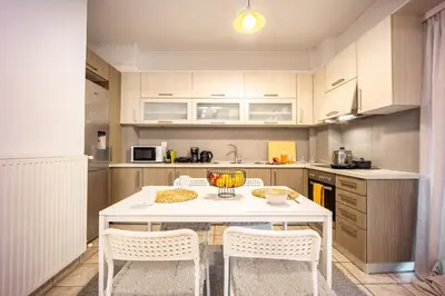 a kitchen with a white table and chairs in it at Perfect Stay in Gazi in Athens