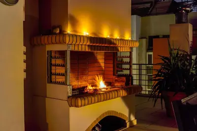 a fireplace with a fire inside of it at Perfect Stay in Gazi in Athens
