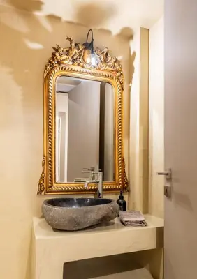 a bathroom with a stone sink and a mirror at MZ Kolonaki in Athens