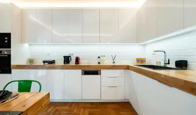 a kitchen with white cabinets and a sink at MZ Kolonaki in Athens