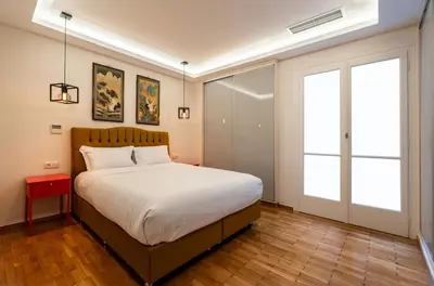 a bedroom with a large bed and a window at MZ Kolonaki in Athens