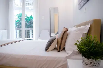 a bedroom with a bed with pillows and a window at Cozy apt near the Acropolis in Athens