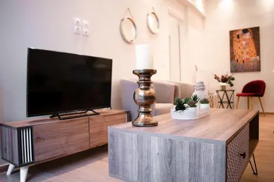 a living room with a flat screen tv on a table at Cozy apt near the Acropolis in Athens