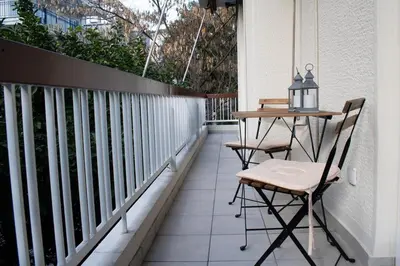 a table and two chairs on a balcony at Cozy apt near the Acropolis in Athens