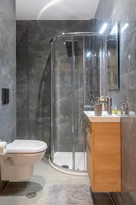 a bathroom with a shower and a toilet and a sink at Modern apt at Thisio next to the metro station in Athens